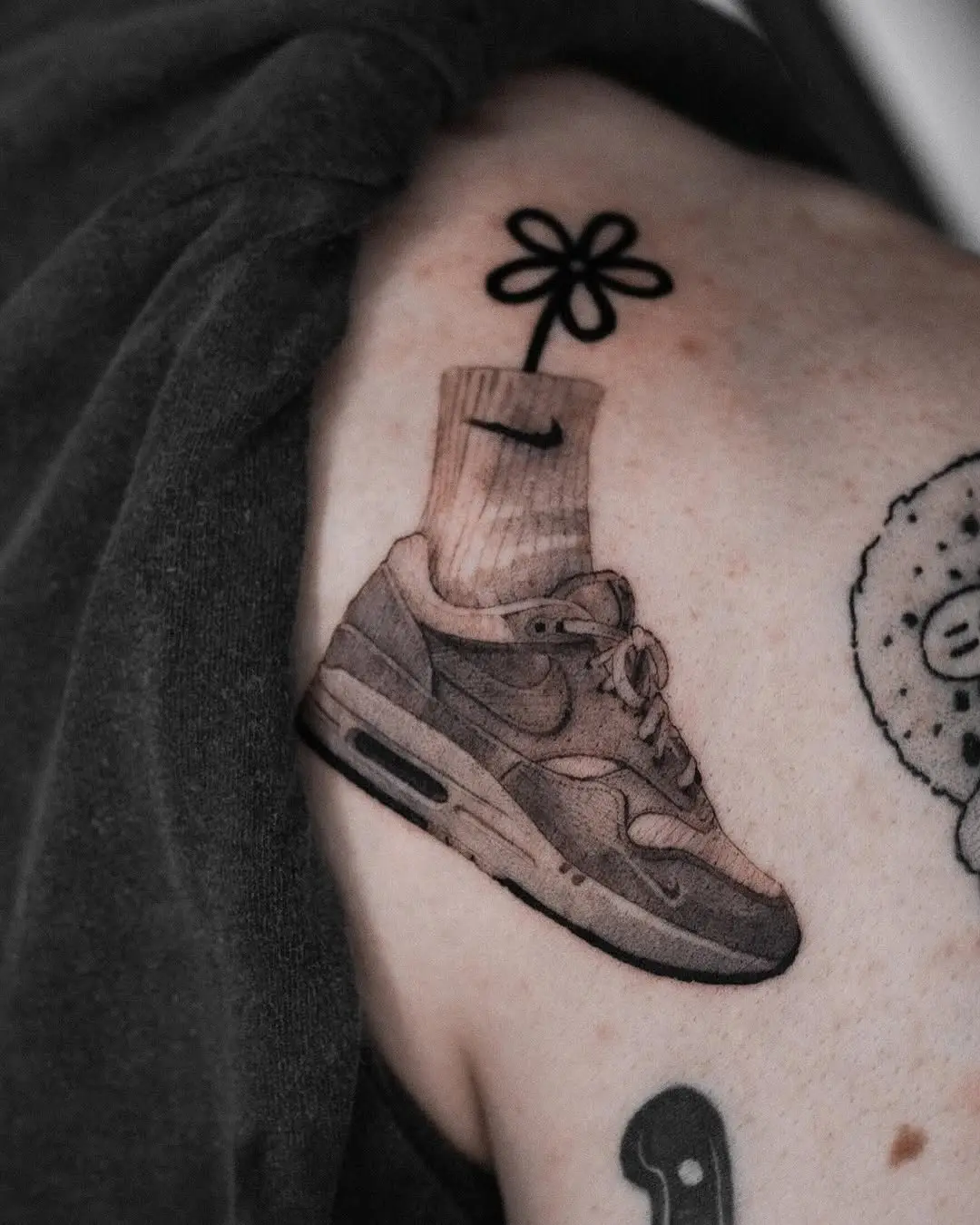 Stylish sneaker tattoo with playful flower detail
