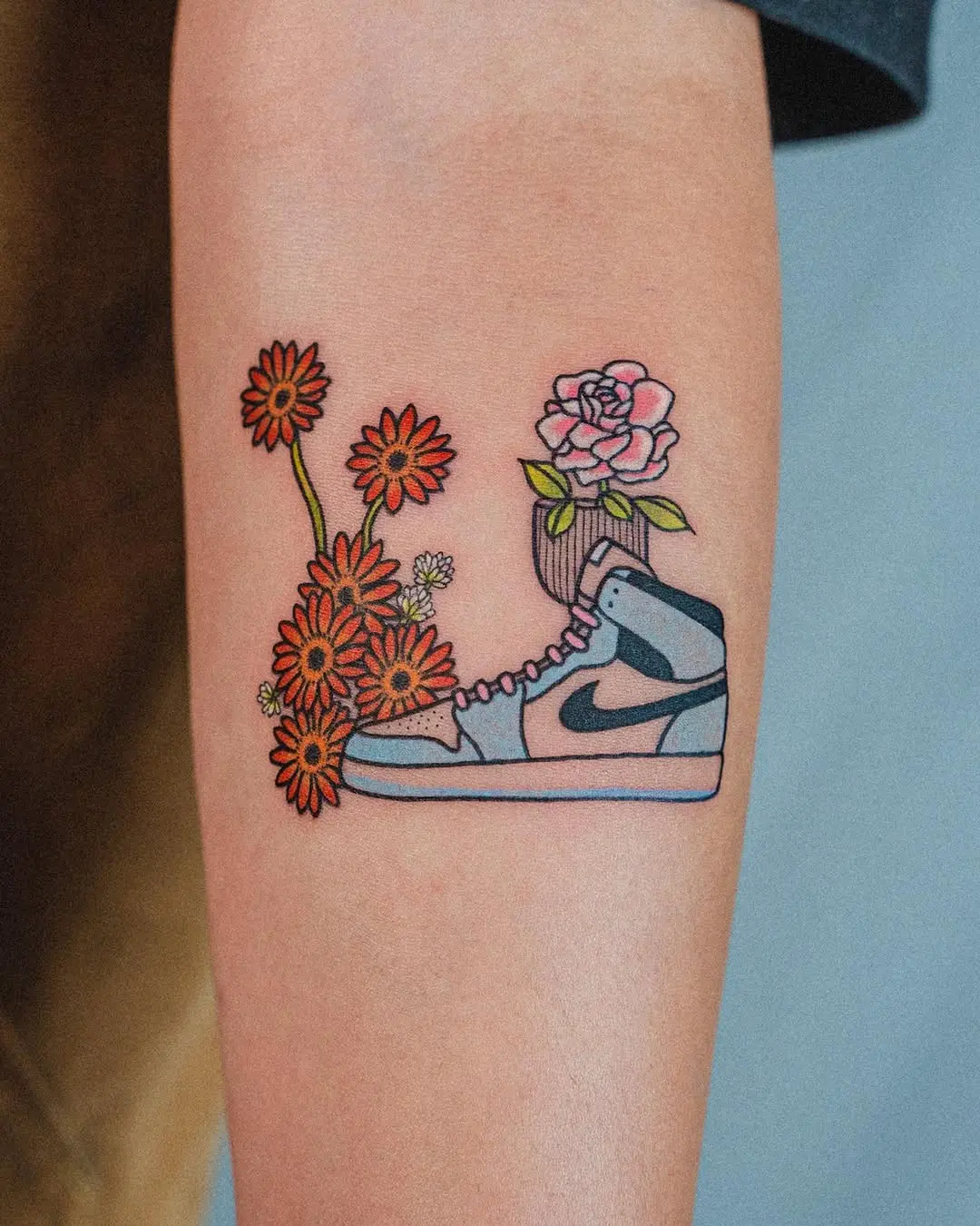 Colorful shoe tattoo with floral elements