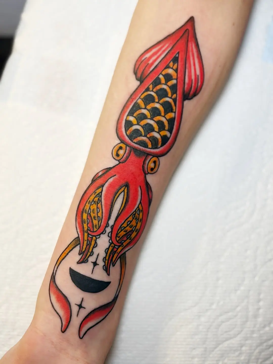 Vibrant squid tattoo showcasing bold colors