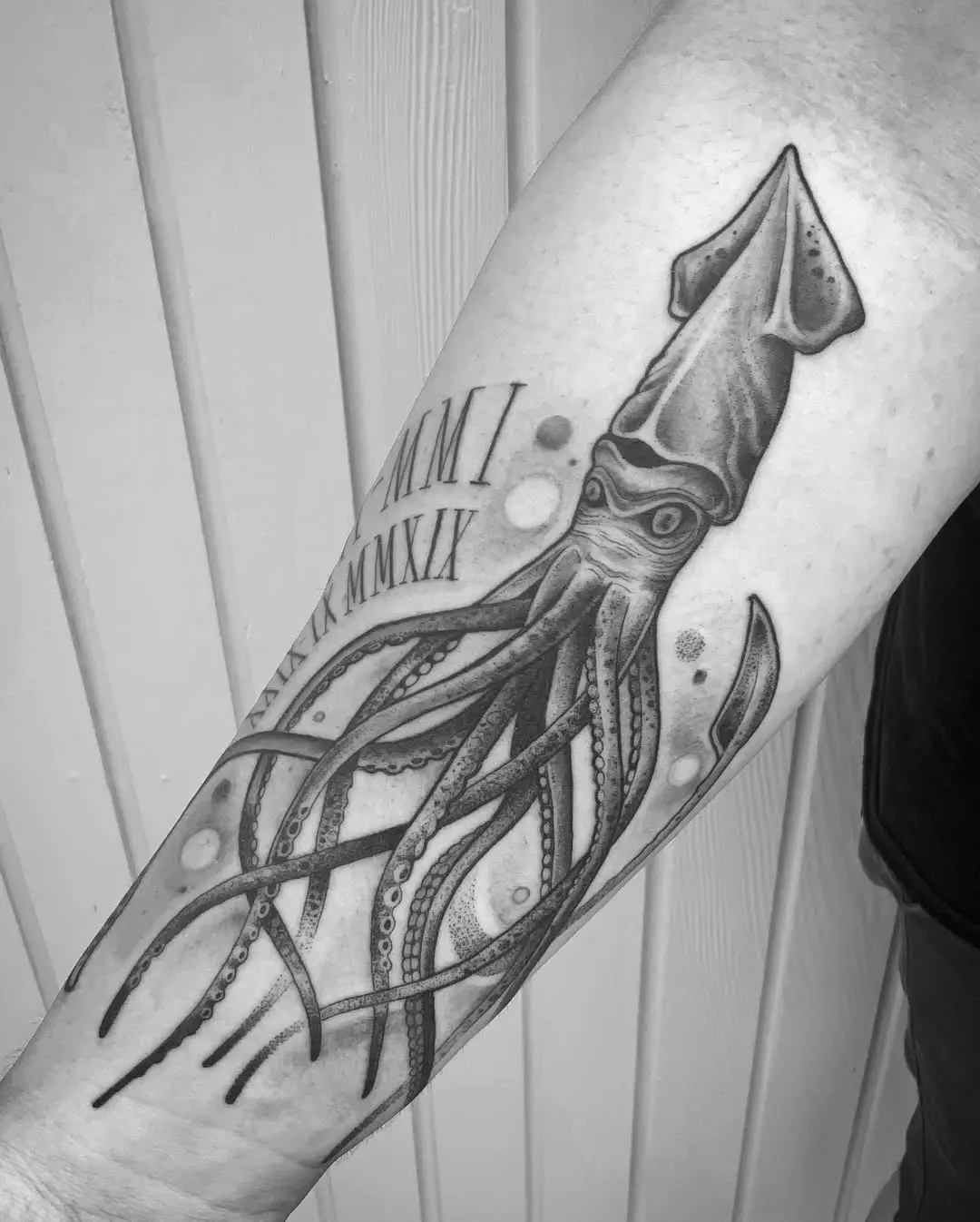 Intricate squid tattoo with flowing tentacles