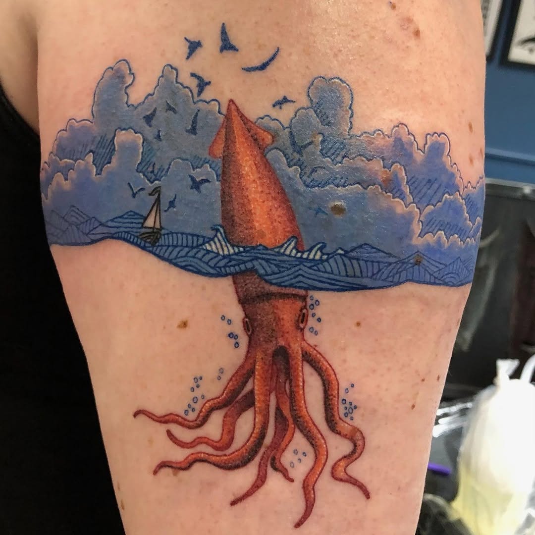 Vibrant squid tattoo amidst ocean waves