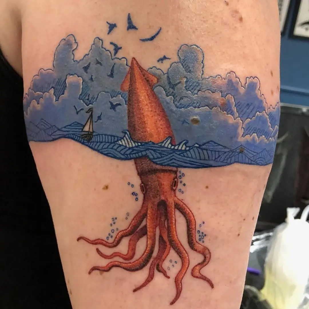 Vibrant squid tattoo amidst ocean waves