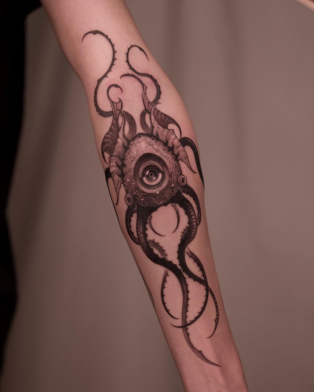 Eerie squid tattoo featuring an eye design