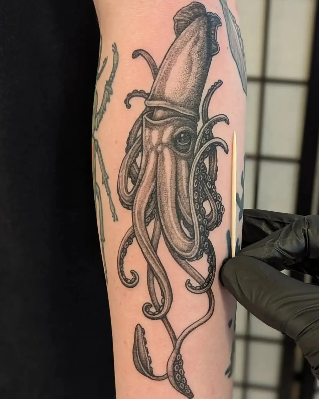 Intricate squid tattoo with detailed artistry