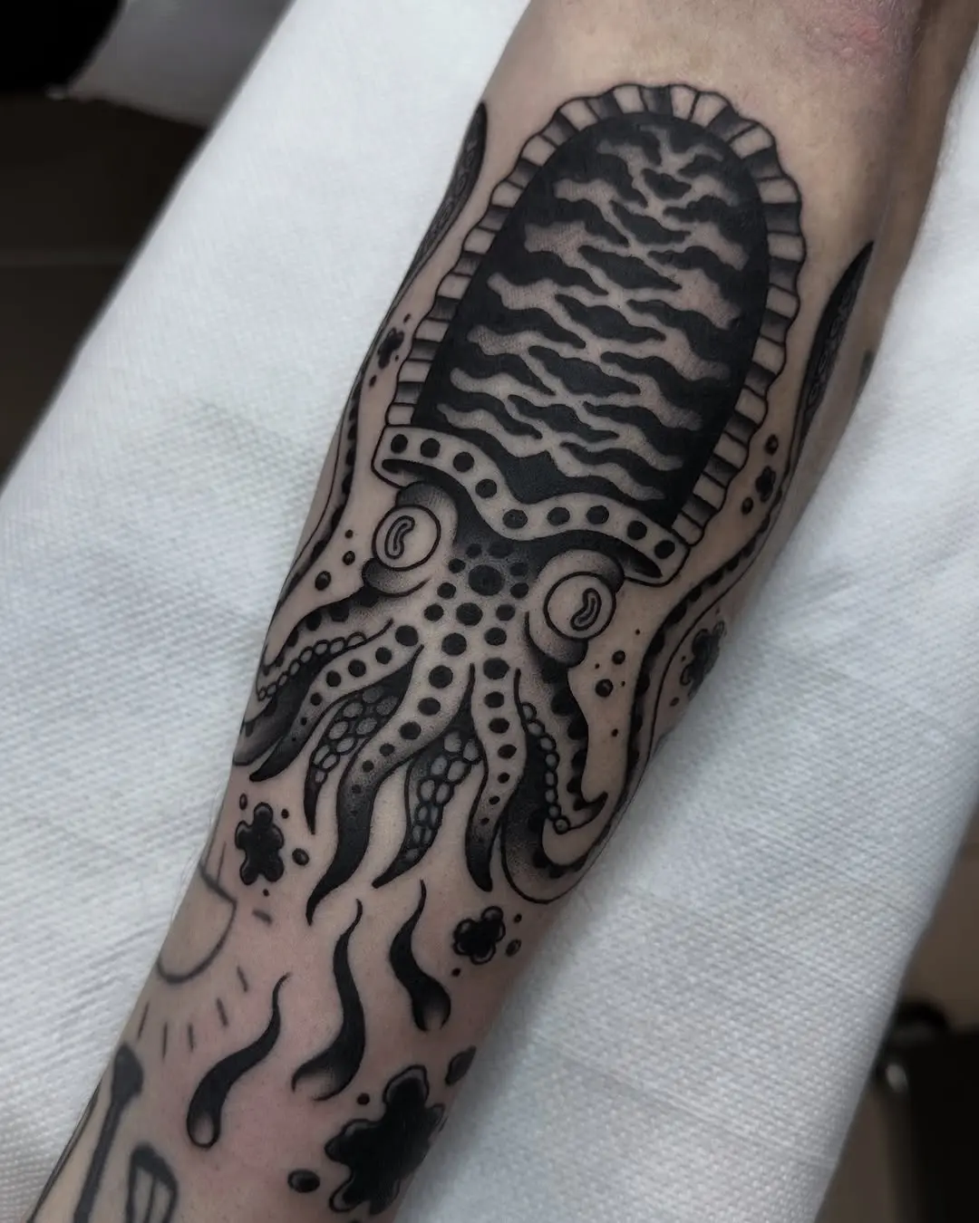 Intricate squid tattoo with bold black details