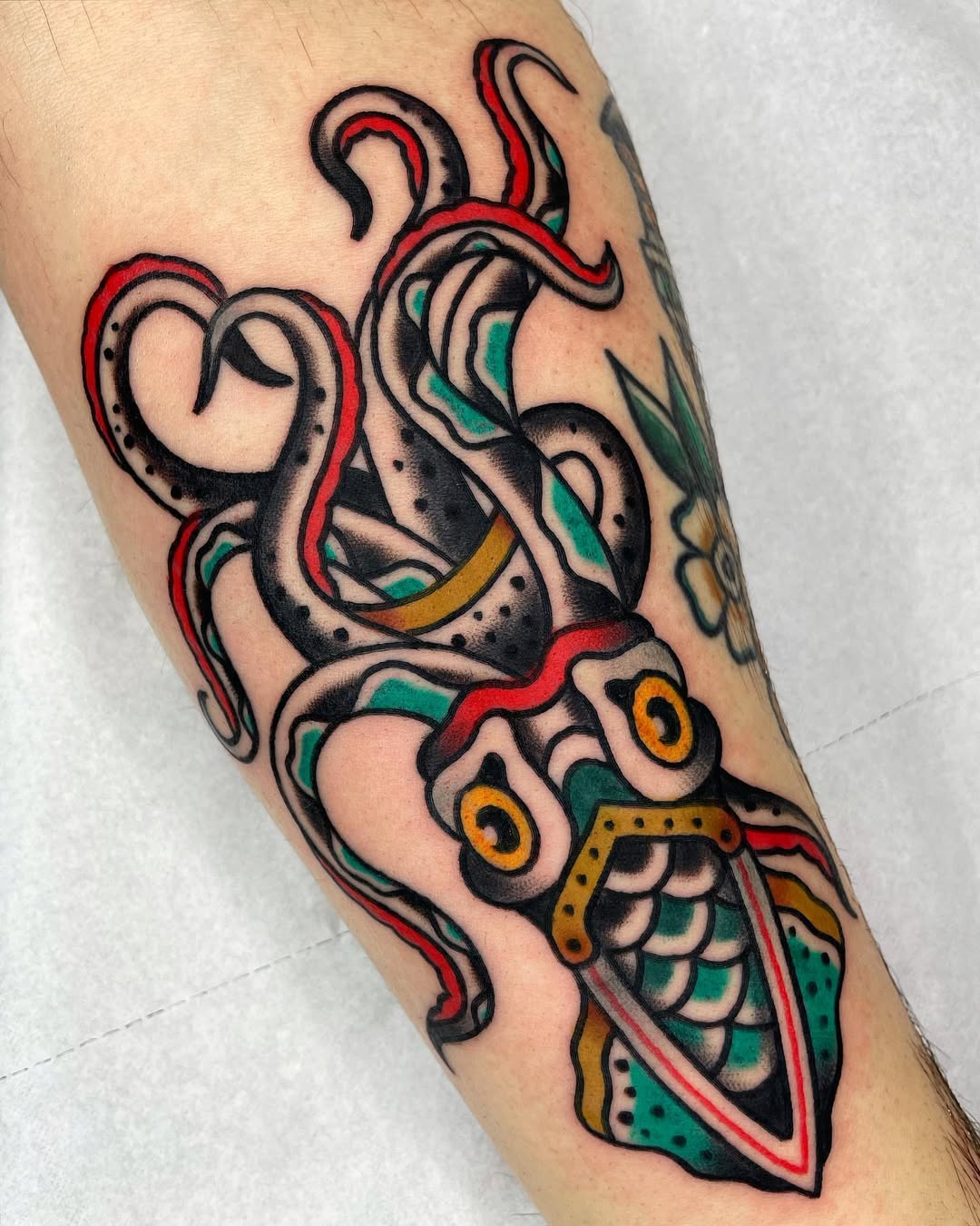 Bold squid tattoo with vibrant colors and details
