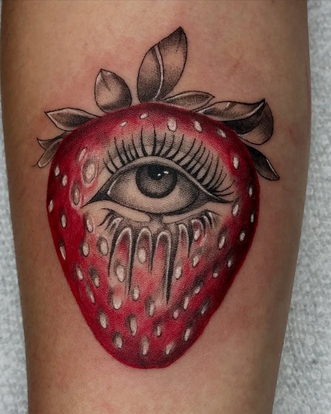 Mesmerizing strawberry tattoo with hidden eye
