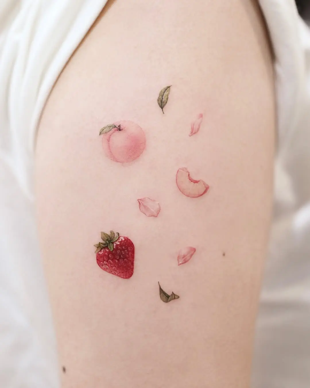 Charming strawberry tattoo with floral accents