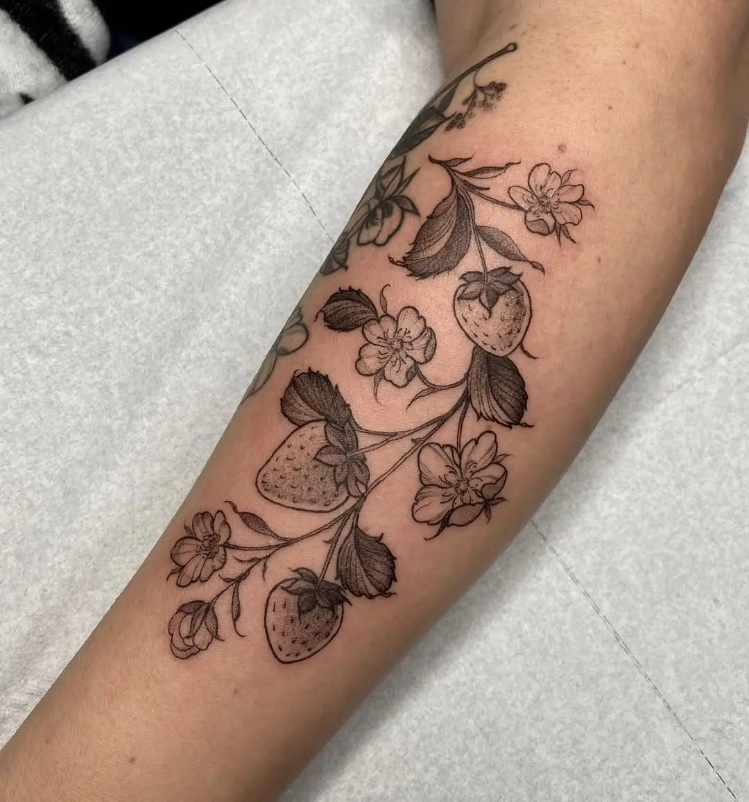 Elegant strawberry and flower tattoo design