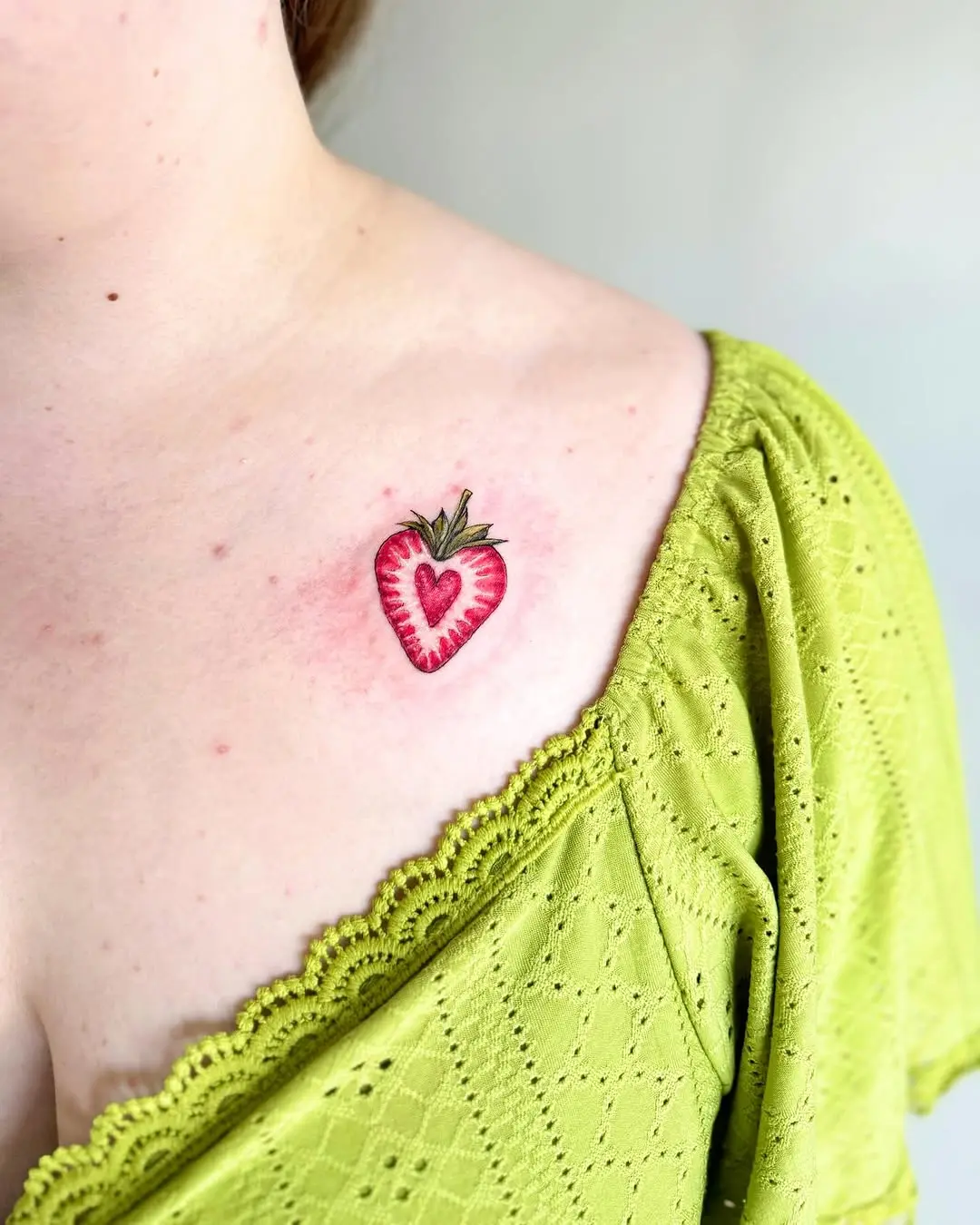 Charming strawberry heart tattoo on shoulder