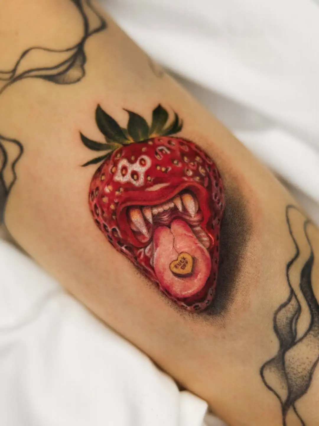 Unique strawberry tattoo with playful elements