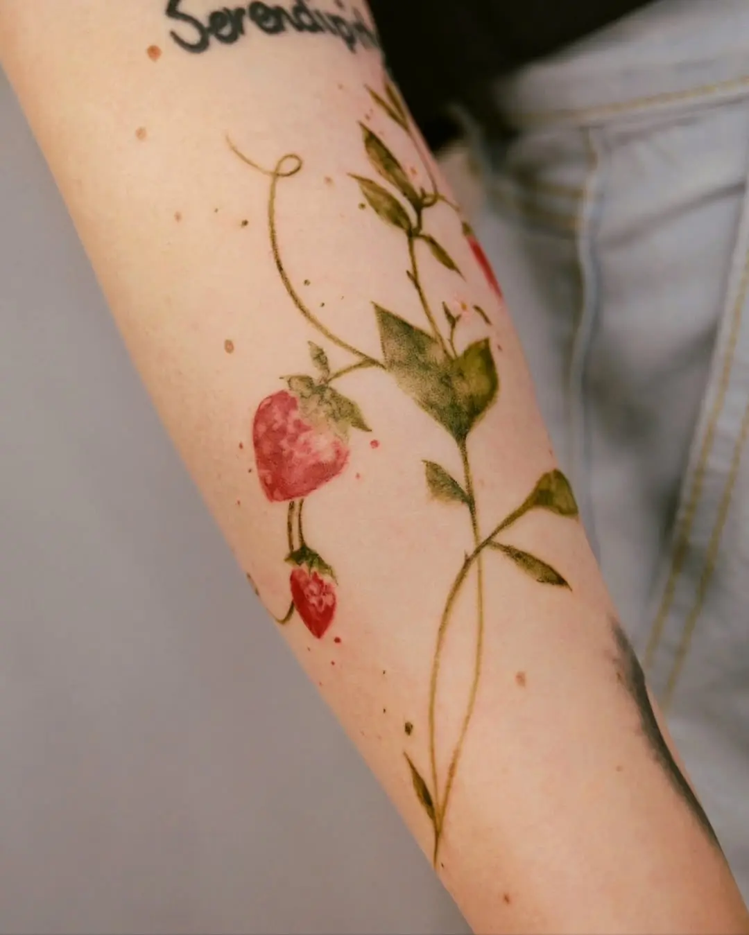 Vibrant Strawberry Tattoo with Floral Elements