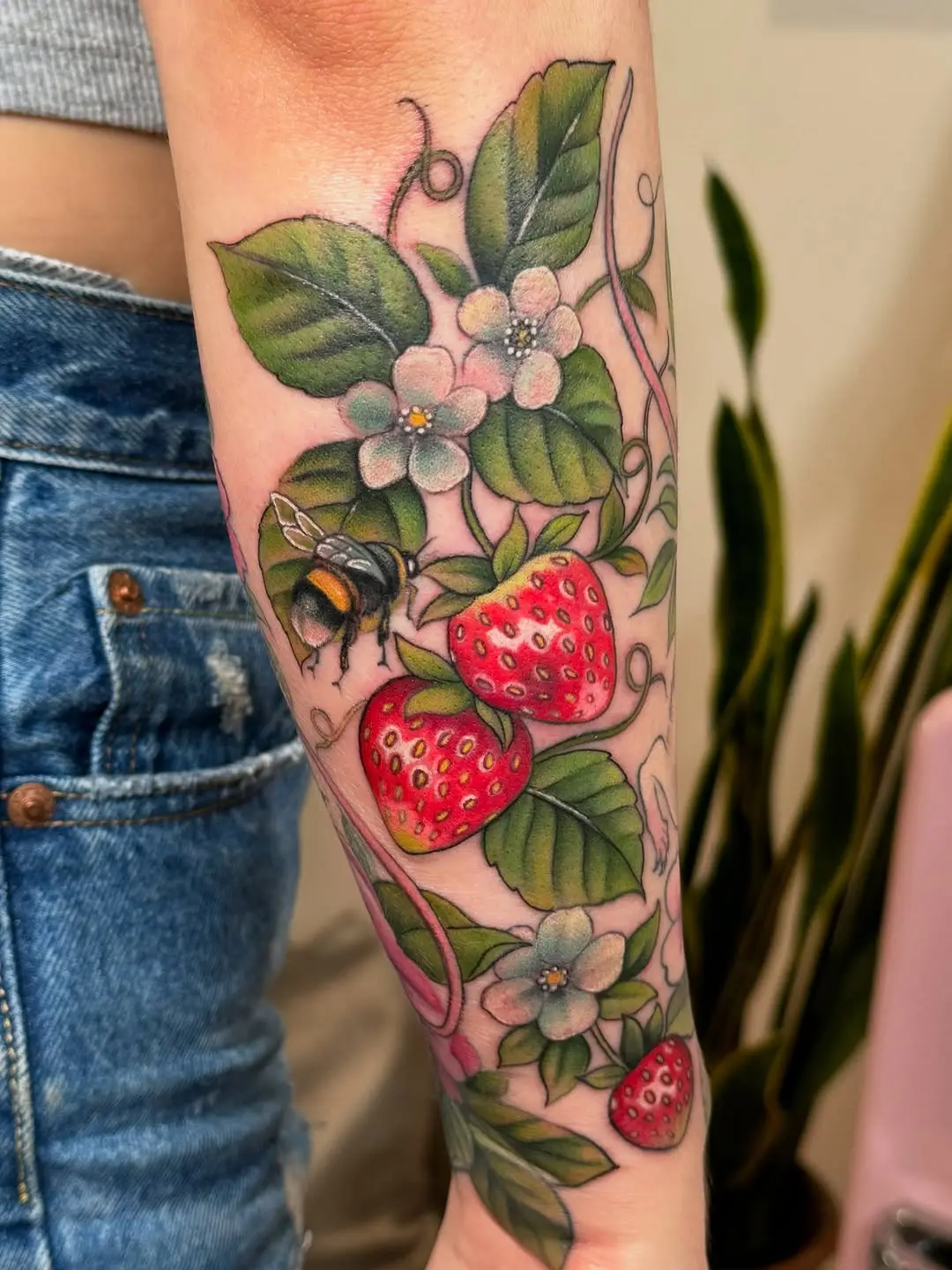 Vibrant strawberry tattoo with floral details