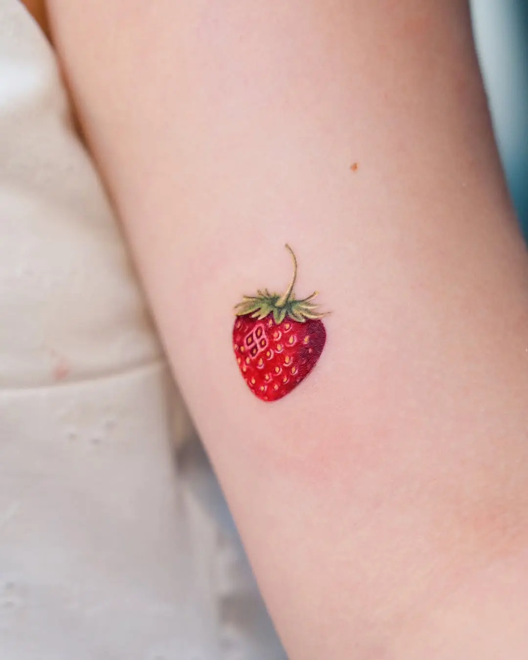 Delicate Strawberry Tattoo on Arm