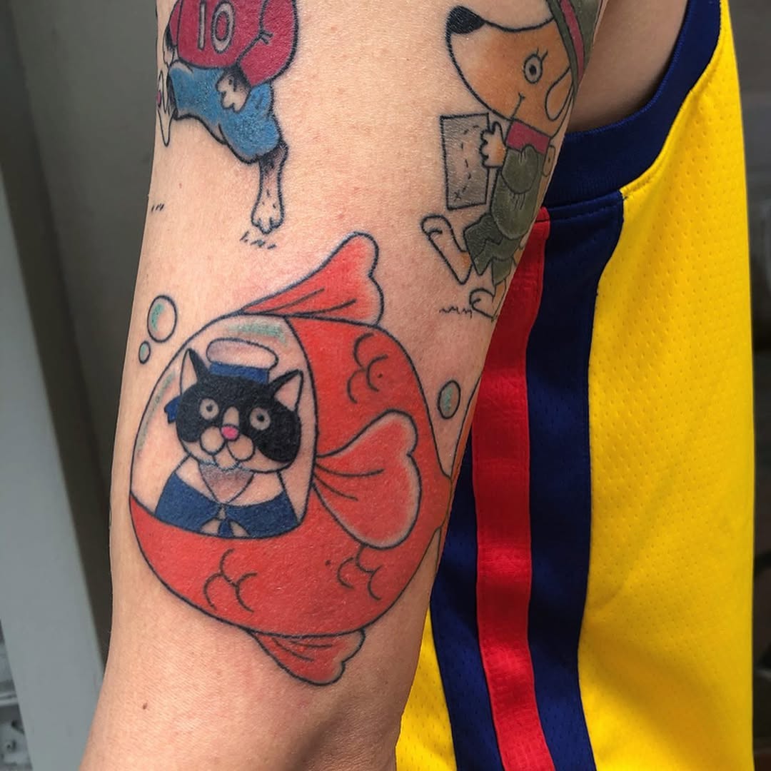 Playful cat in a submarine design tattoo
