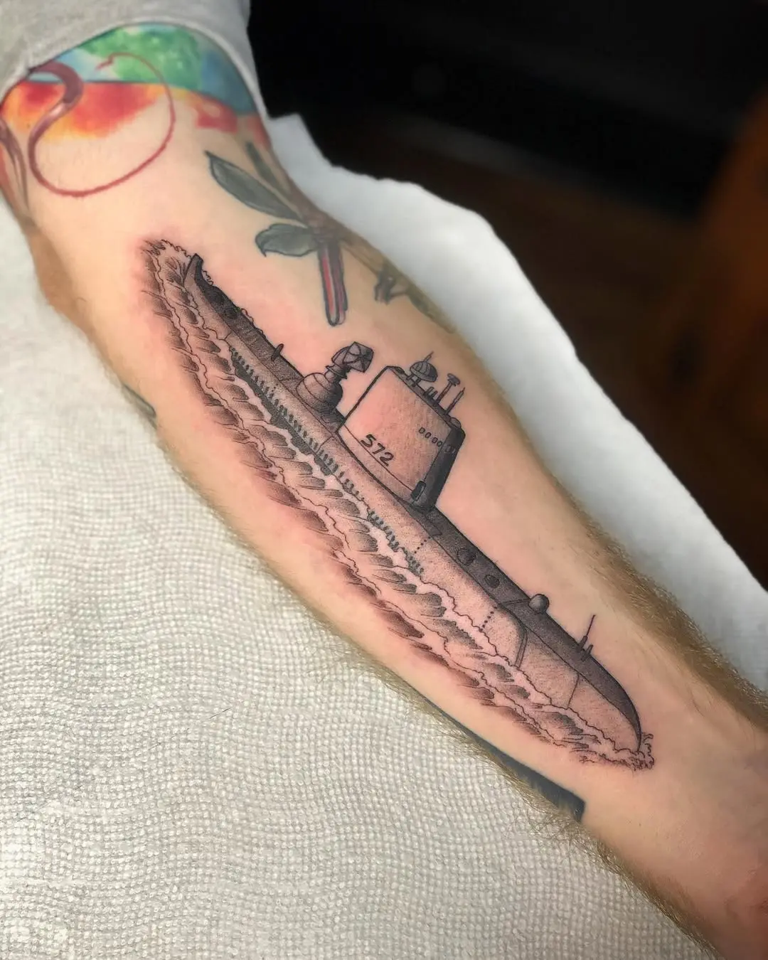 Detailed submarine tattoo on a forearm