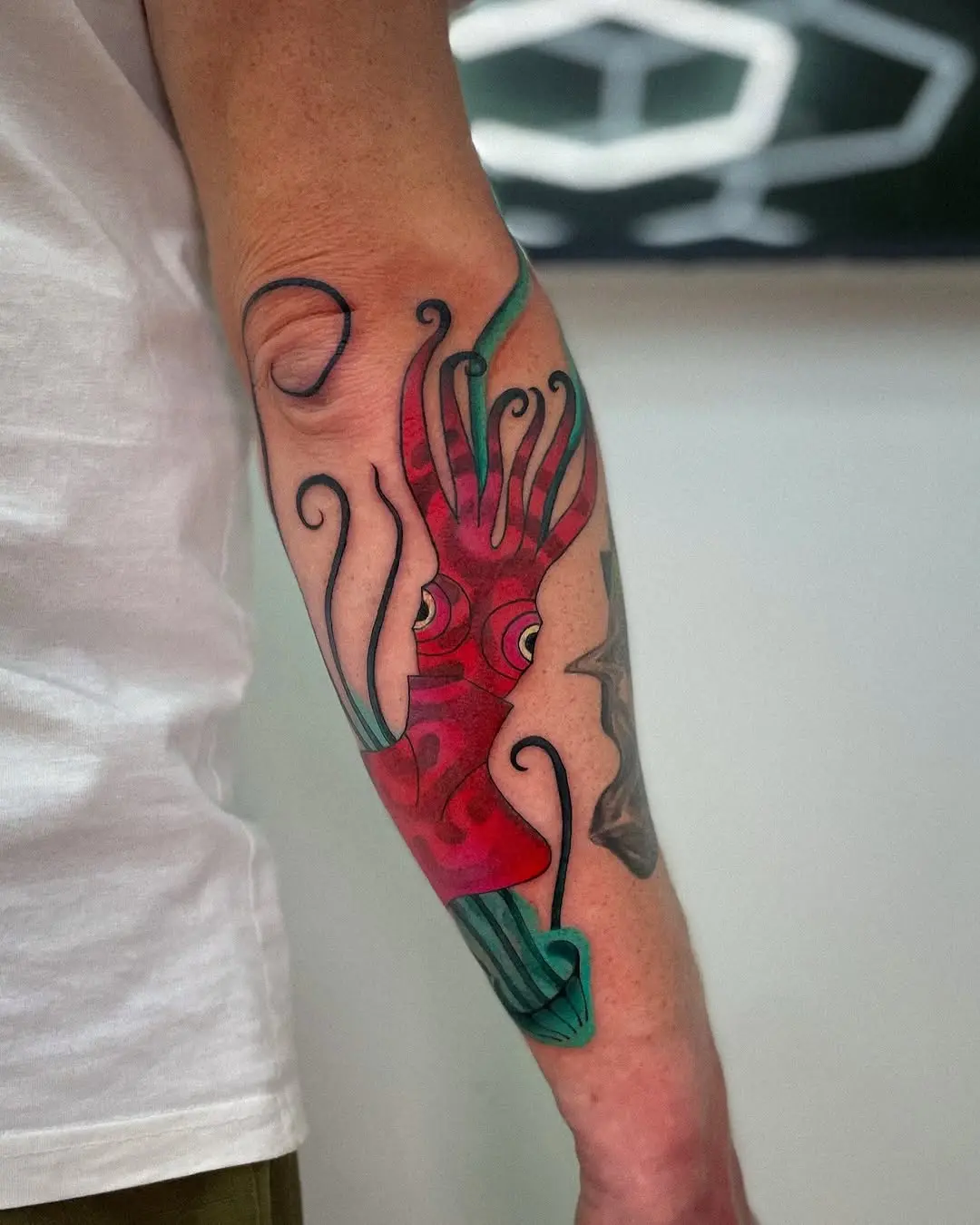 Intricate squid tattoo bursting with colors