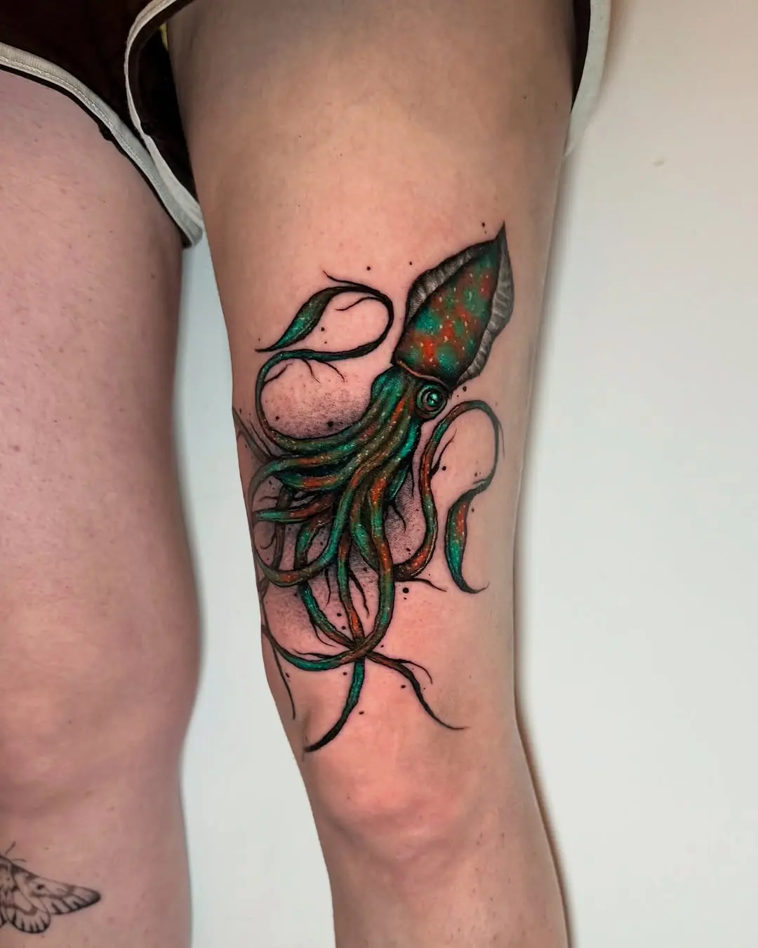 Colorful squid tattoo showcasing detailed artistry