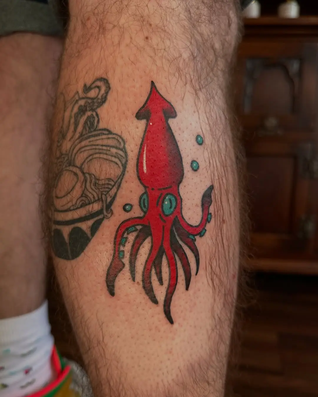 Vibrant squid tattoo on the lower leg
