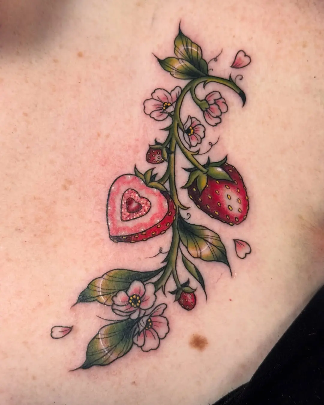 Charming strawberry tattoo with floral accents