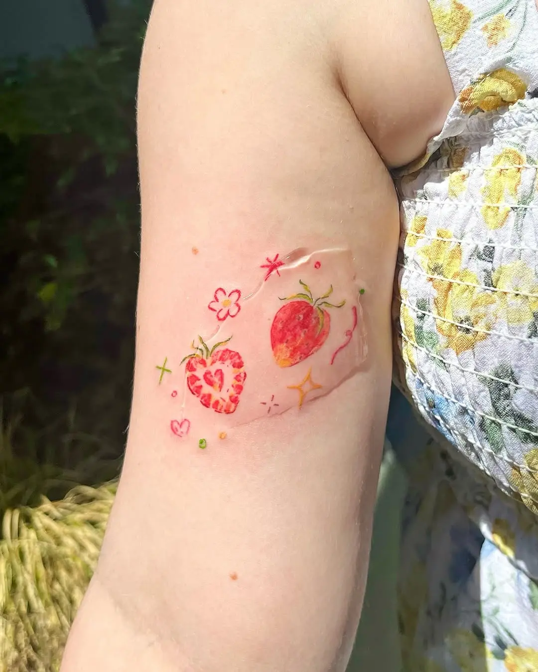Colorful strawberry tattoos radiating summer vibes