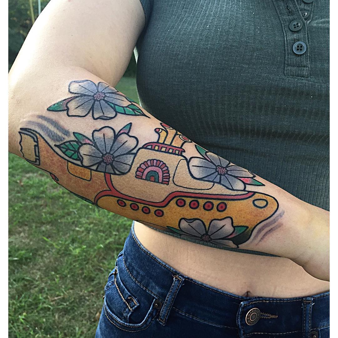 Colorful submarine tattoo with floral elements