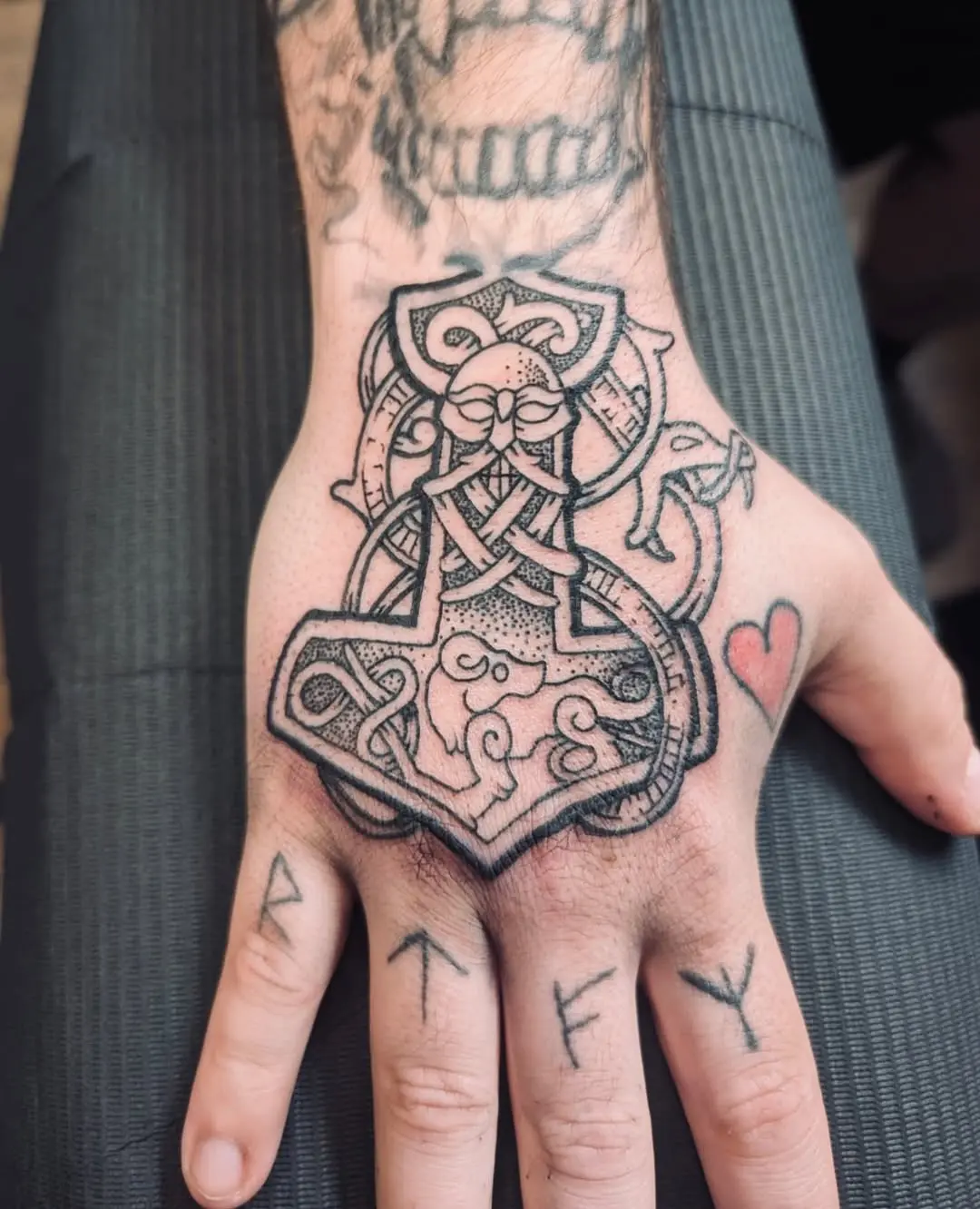 Intricate Viking knot tattoo on a hand