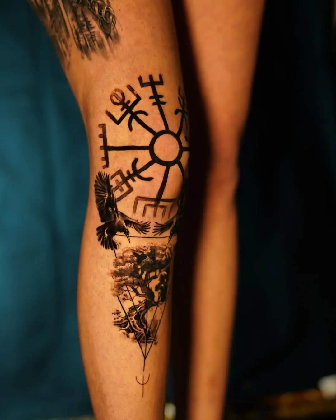 Intricate Viking tattoo featuring runes and nature