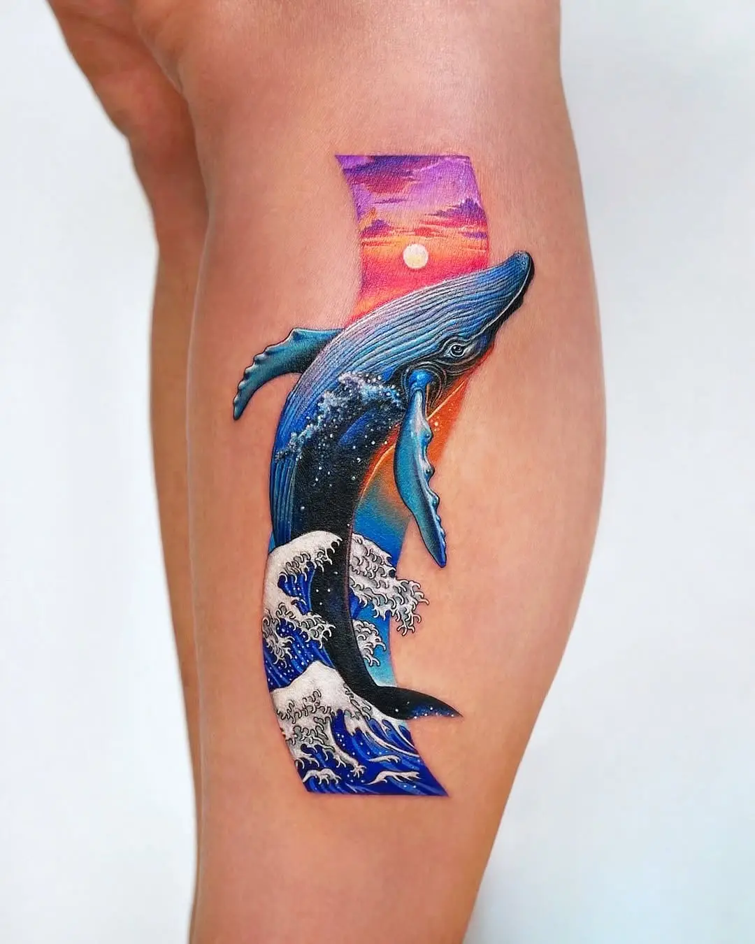 Vivid whale tattoo amidst ocean waves
