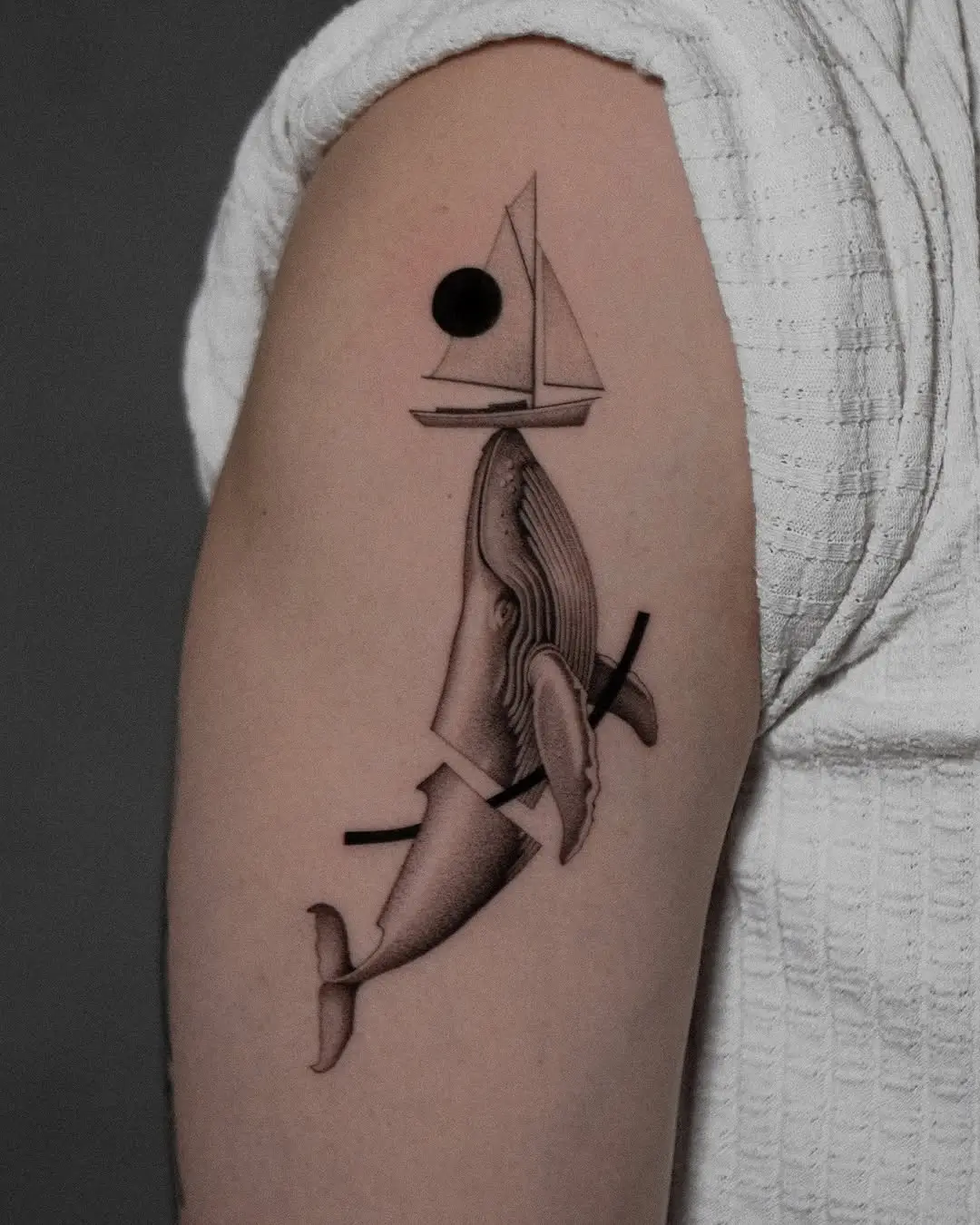 A unique whale sailing tattoo design