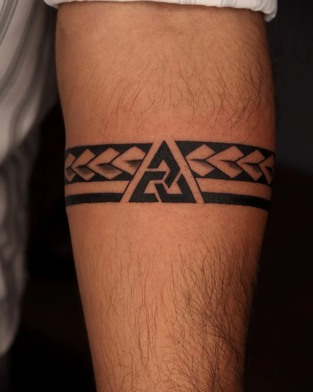 Bold geometric armband tattoo with tribal elements