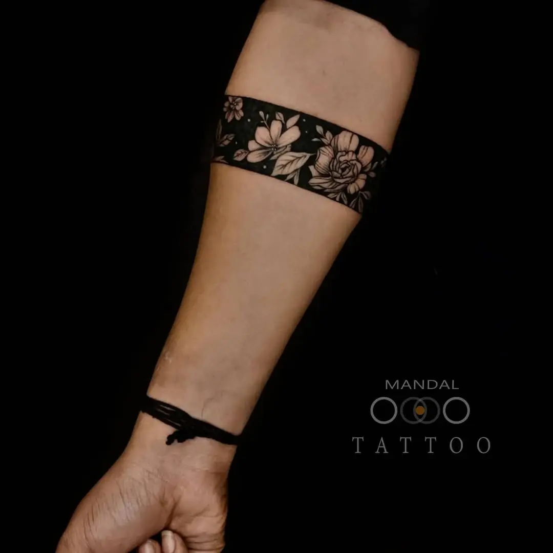 Elegant floral armband tattoo featuring bold design