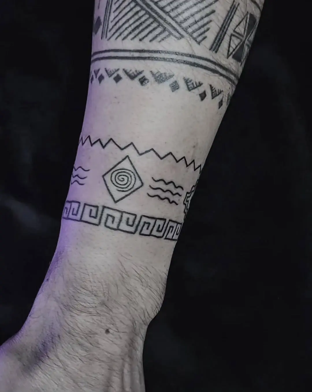 Unique geometric armband tattoo with cultural elements