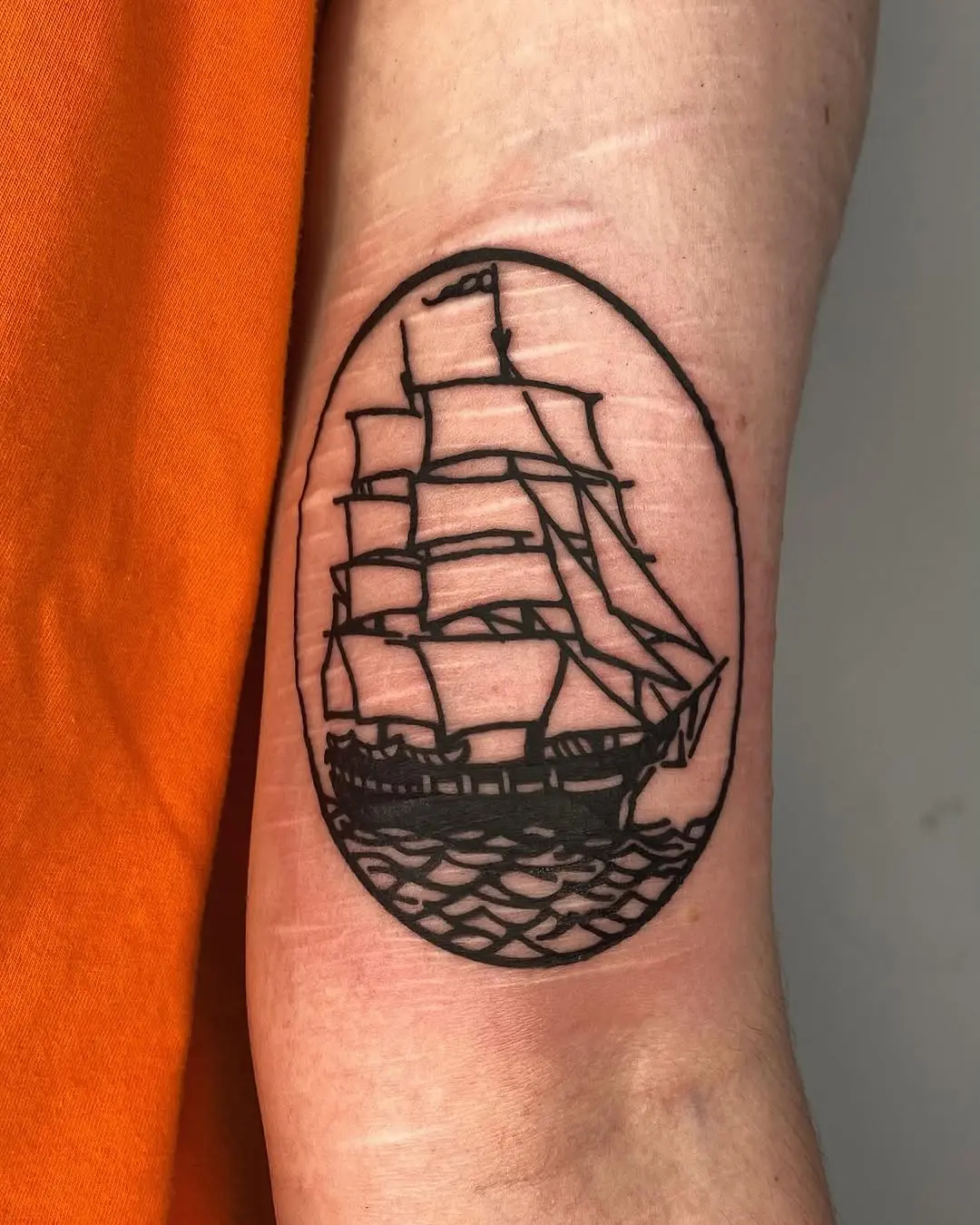 Classic ship tattoo with bold outlines
