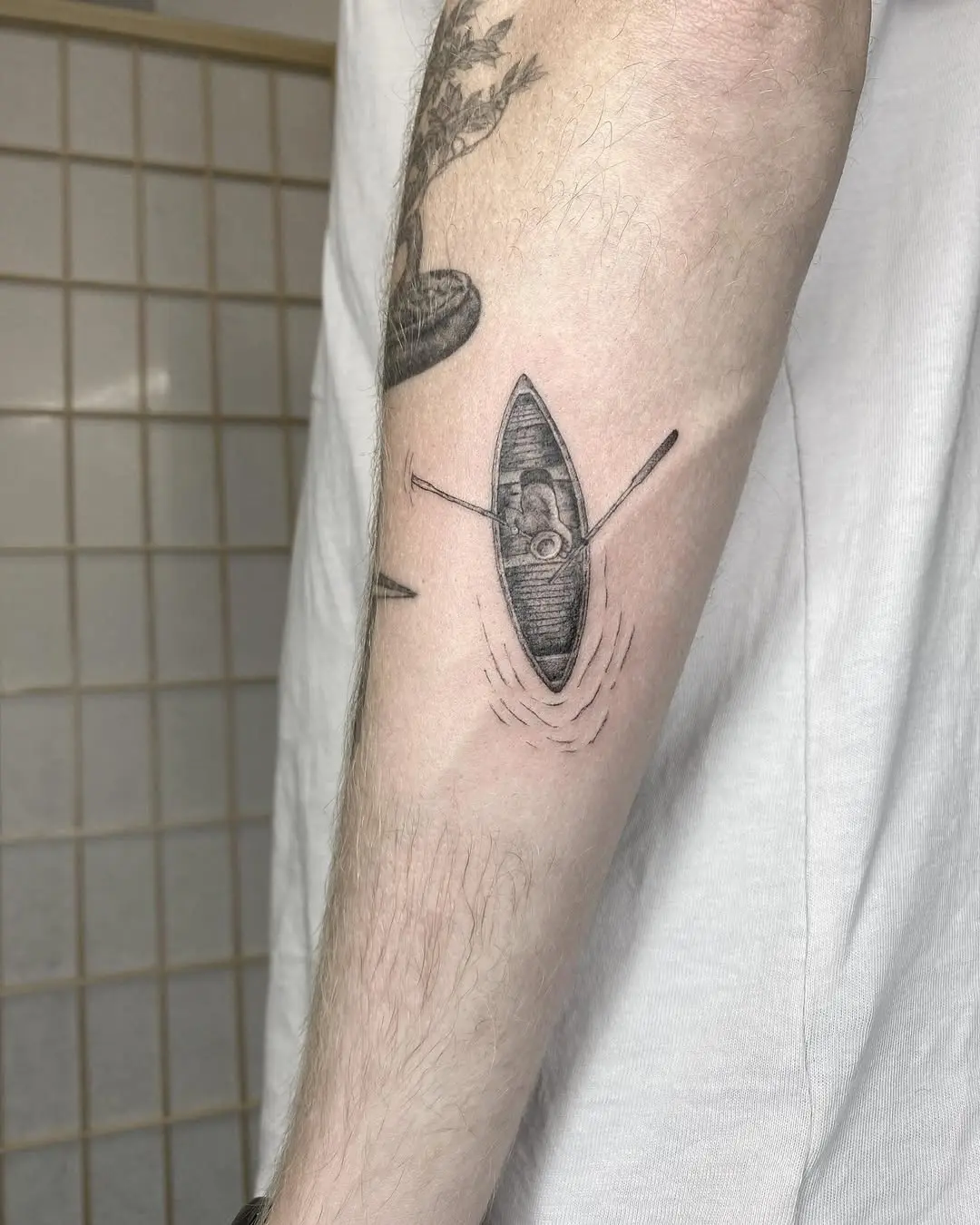 A unique kayak tattoo with serene vibes