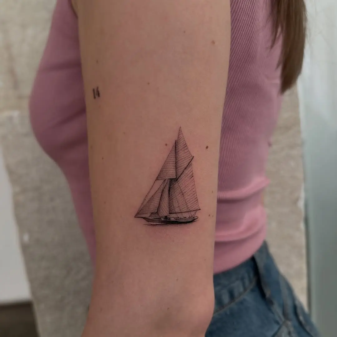 Elegant sailing boat tattoo on forearm.