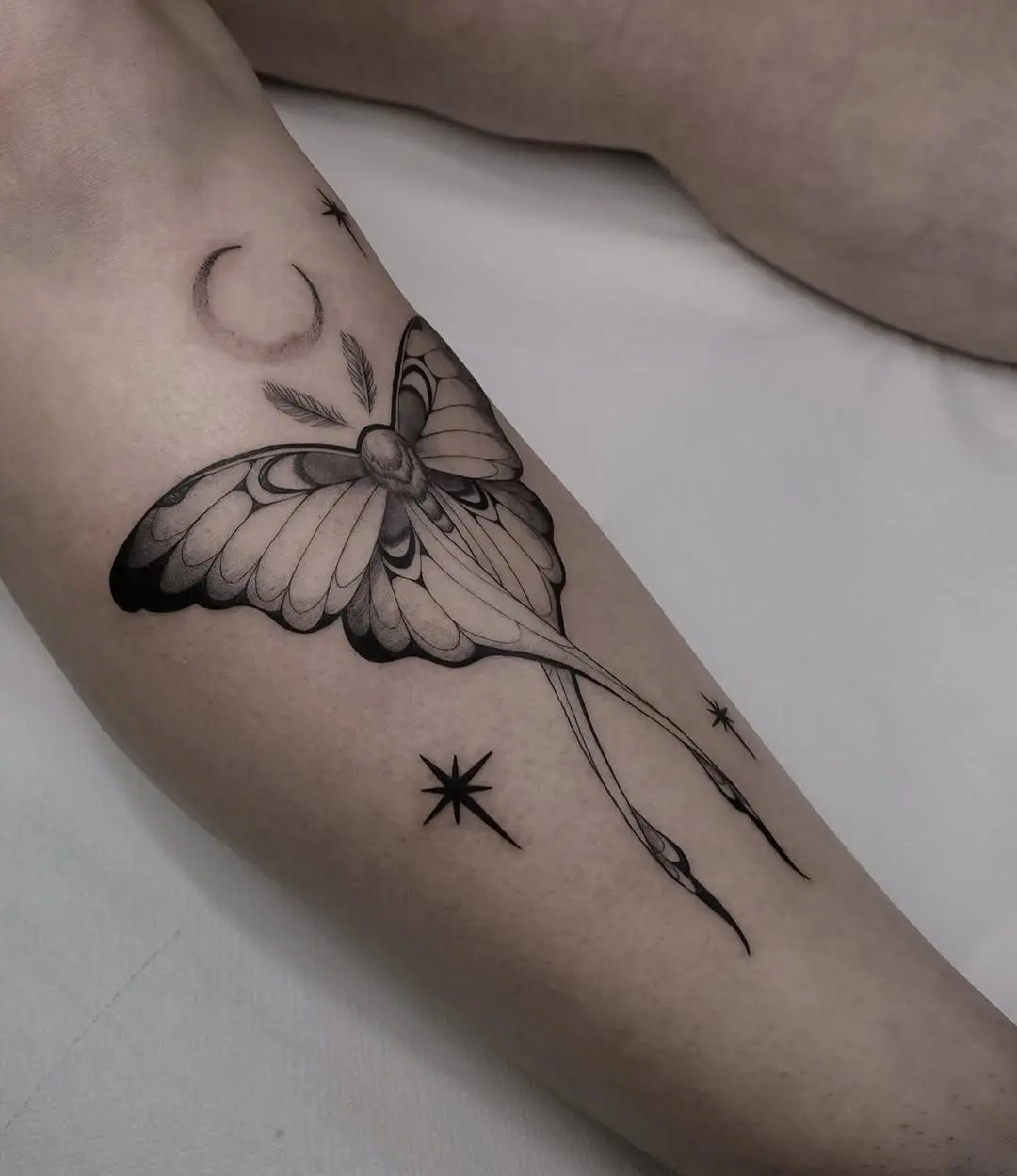 Stunning butterfly tattoo with celestial elements