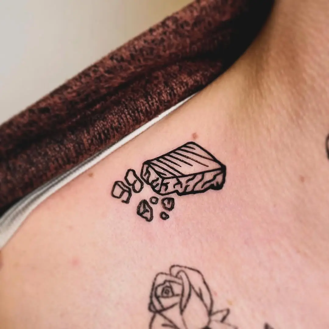 Cracked cheese tattoo on the shoulder