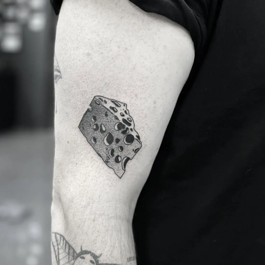Quirky cheese tattoo on the arm