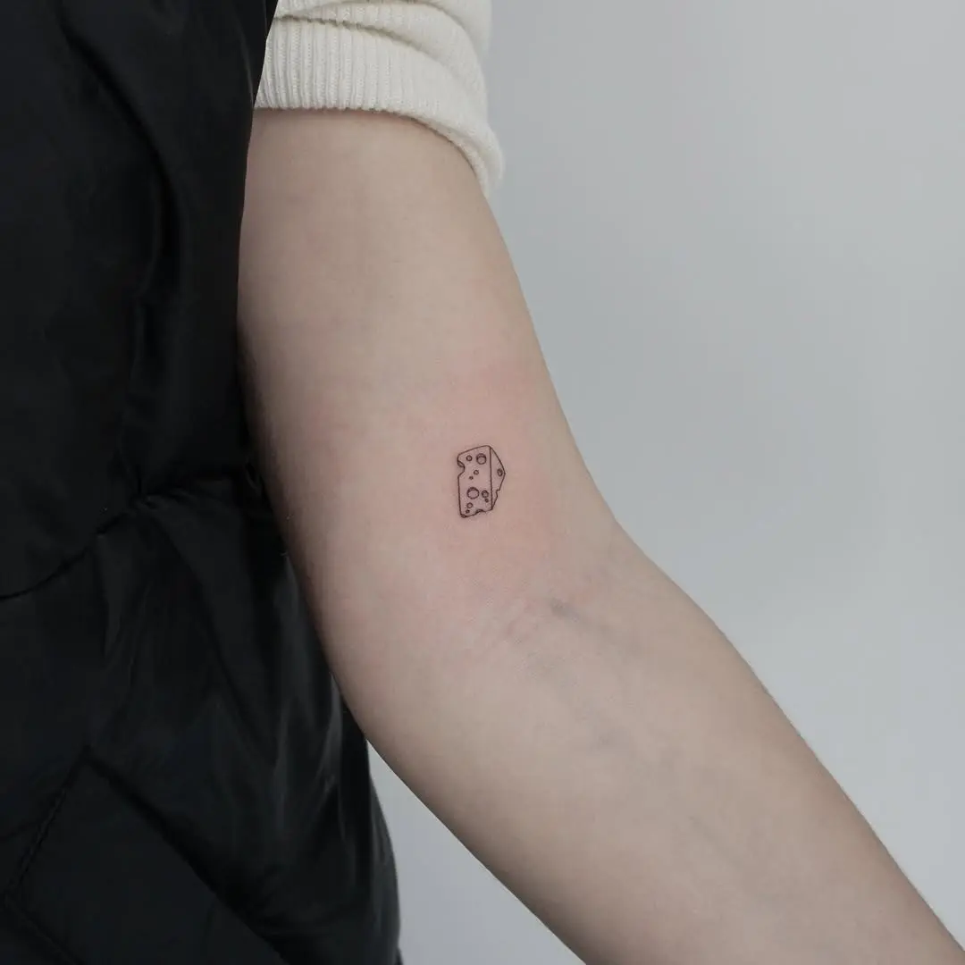 Charming minimalist cheese tattoo design