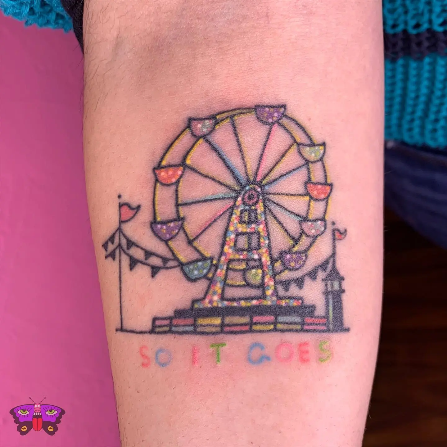 Whimsical Ferris wheel tattoo with bright colors