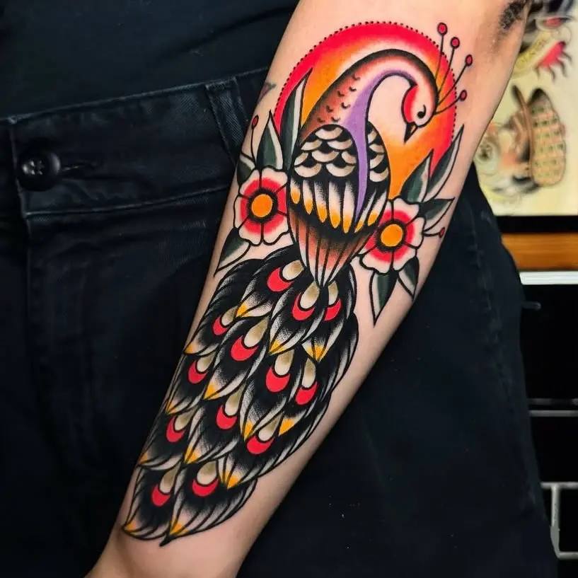 Vibrant peacock tattoo with floral accents