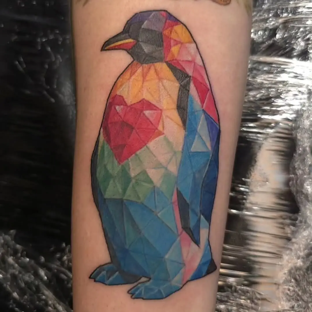 Vibrant geometric penguin tattoo design