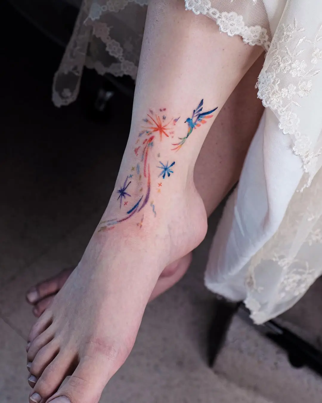 Colorful shooting star tattoo on ankle