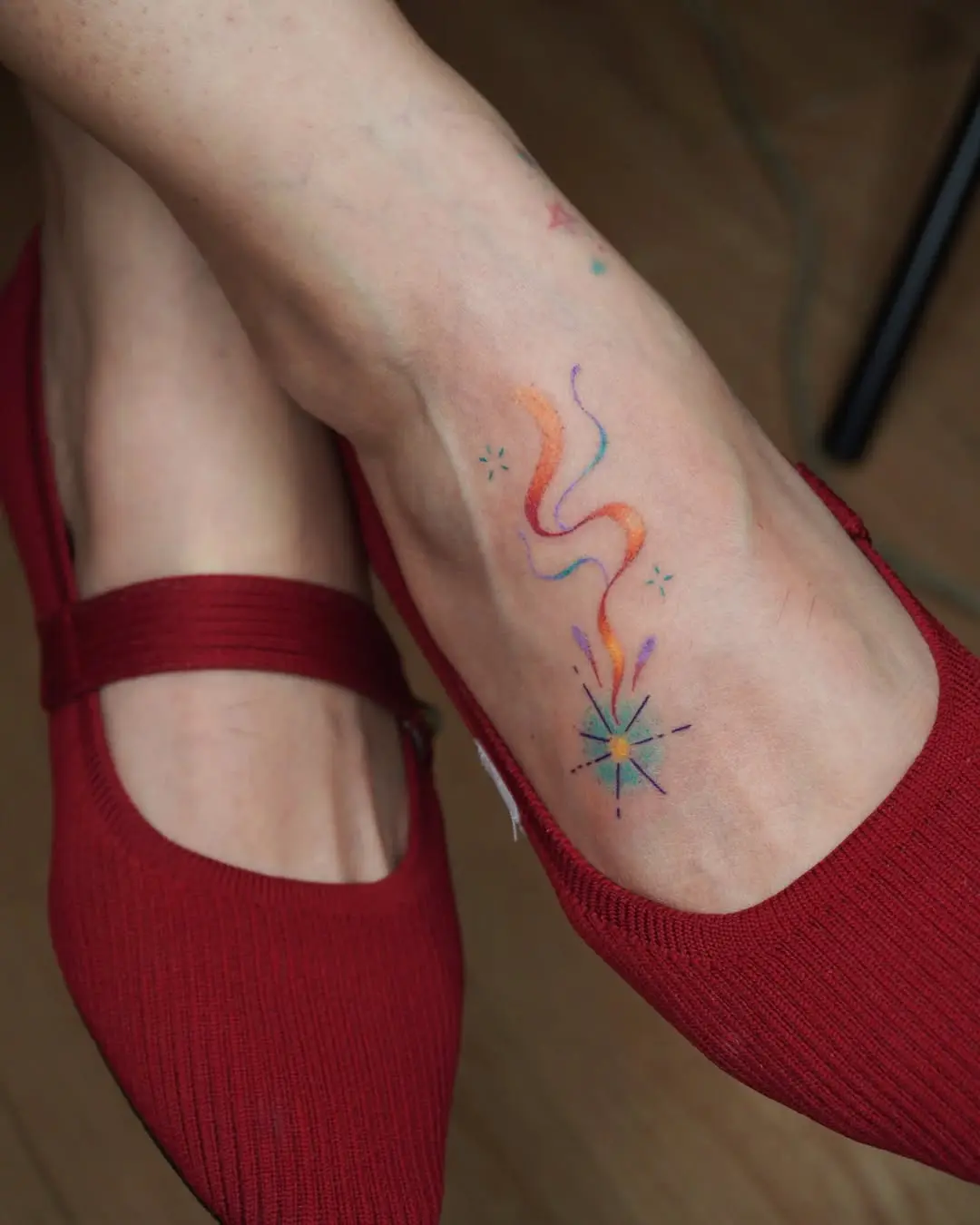 Colorful shooting star design on the ankle