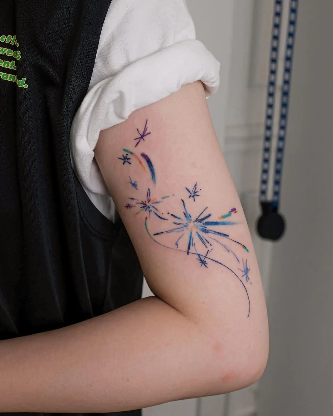 Vibrant shooting star tattoo on the arm