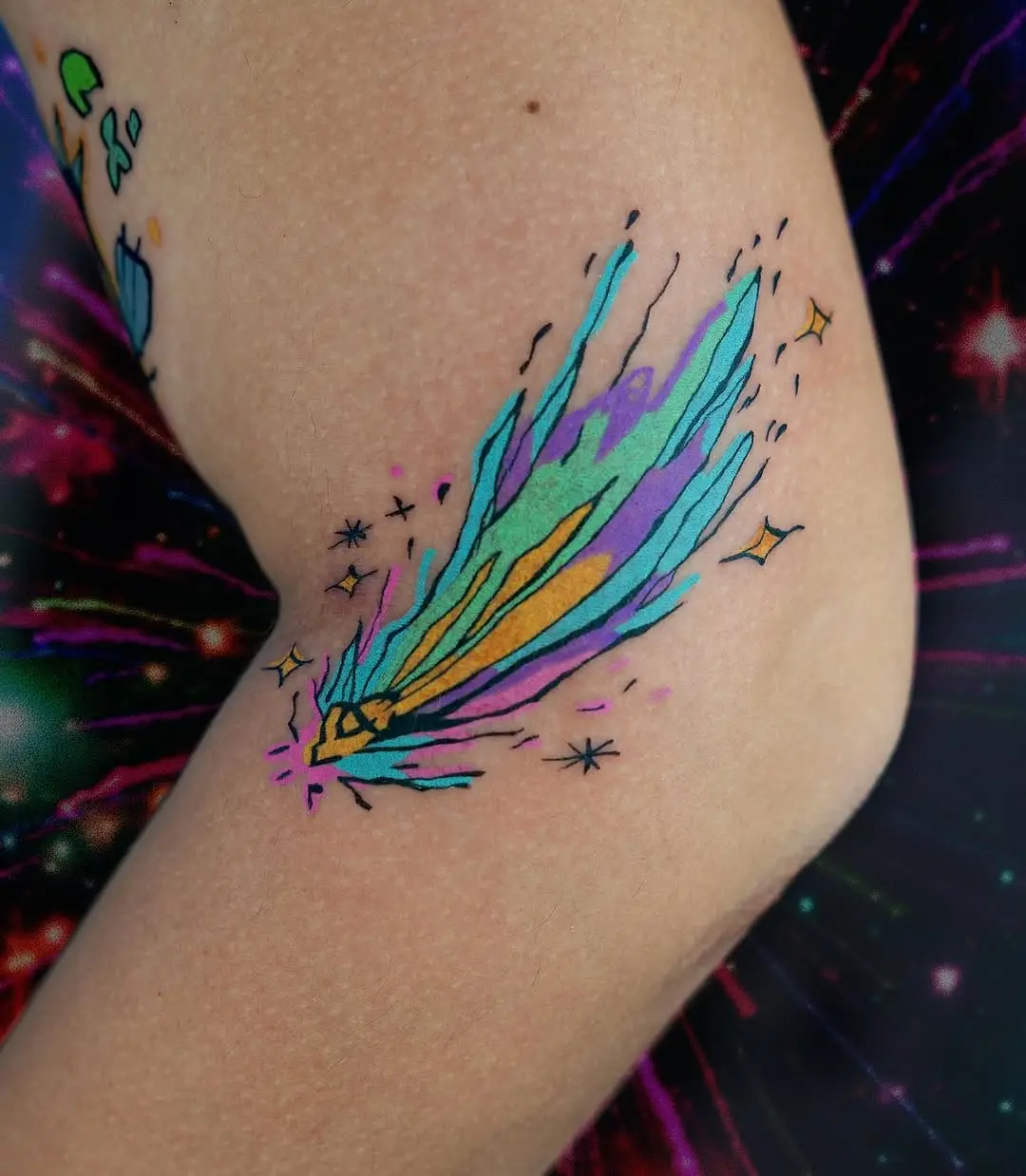 Colorful shooting star tattoo with vibrant hues