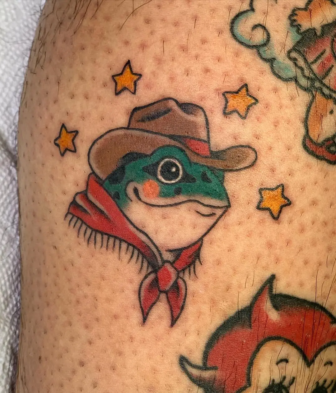 Quirky cowboy frog tattoo with stars
