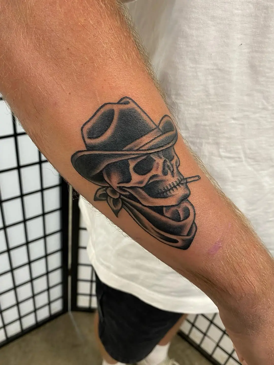 Stylish cowboy skull tattoo with bandana flair