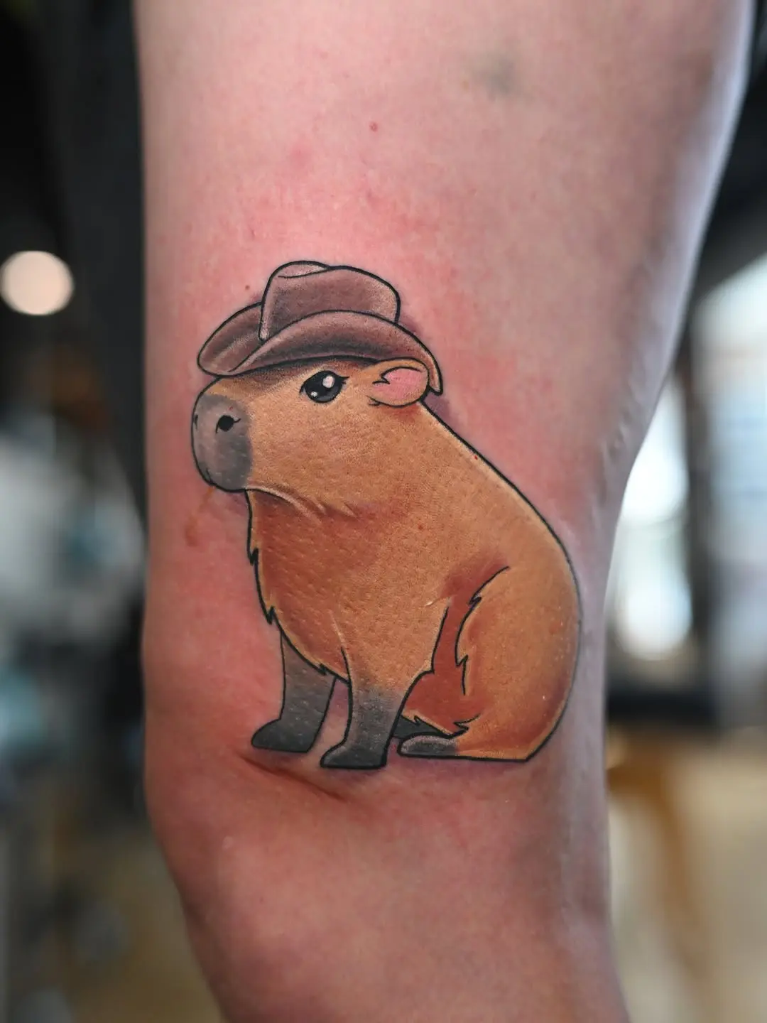 Charming capybara wearing a cowboy hat tattoo